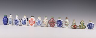 A group of 13 blue and white and enamelled snuff bottles, 20th century, comprising 6 blue and white, four famille rose, a blue-glazed, an iron-red and a famille verte bottle, painted with dragons, fruit, flowers, lions and figures (13)