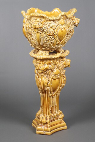 A French Art Nouveau mustard coloured jardiniere and stand decorated with lions and claw feet 49cm