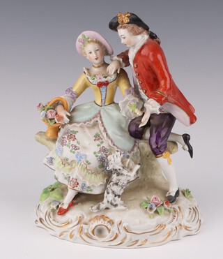 A Sitzendorf porcelain group of a couple with a dog at their feet, raised on a rococo base 17cm 