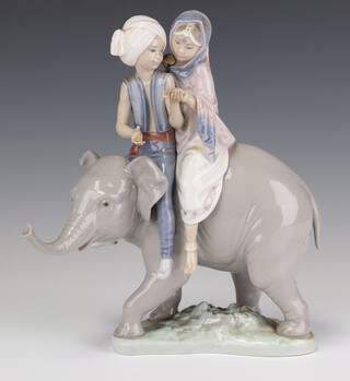 A Lladro group of 2 young people riding a baby elephant no. 3352, dated 25/11/88, signed 22cm 