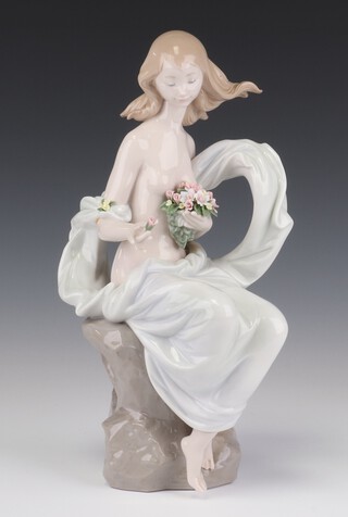 A Lladro figure of a seated semi clad lady no. 6708 Serene Moment, 30cm 