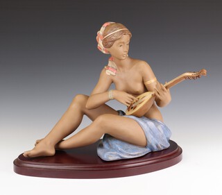 A Lladro matt figure of a semi clad seated lady playing a mandolin no. 39, signed by Alfredo Llarem no. 7678 on a wooden plinth 32cm 