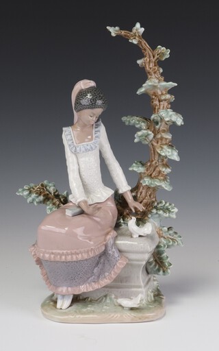 A Lladro figure of a girl sitting on a plinth beside a dove, beneath a tree no. 5159, 30cm 