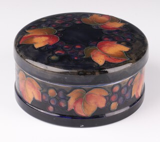 A William Moorcroft circular bowl and cover decorated with grapes and leaves, impressed and signature marks 13cm 