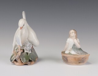 A Royal Copenhagen figure of a girl sitting in a walnut shell 4374 9cm and a ditto of 2 doves 402 14cm