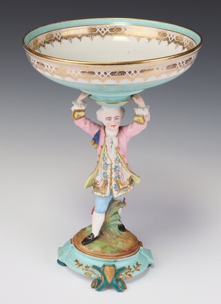 A 19th Century Continental bisque centre piece in the form of a man holding aloft a shallow dish, raised on a scroll base 31cm 