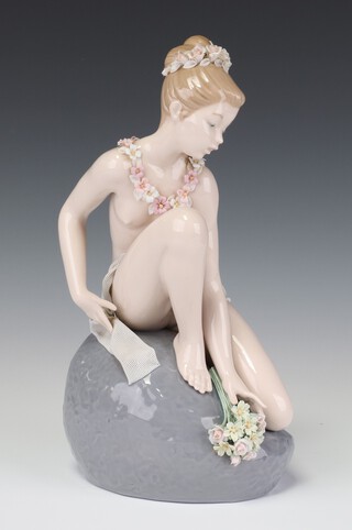 A Lladro figure of a nymph sitting on a rock no. 1601 27cm 