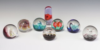 Seven Caithness paperweights - Aquamarina 1472 7cm, a Kismet 29476 8cm, Snow Flame 394/750 7cm, Floral Illusion 534, Selene 742/750 7cm, Touchdown 541/1000 7cm and a tall ditto Coppice 1320708 12cm 