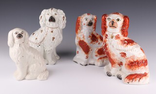 A Victorian Staffordshire white glazed spaniel with gilt decoration 22cm, an ochre ditto 24cm, a smaller ditto 20cm (cracked) and a white ditto 18cm 