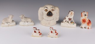 A Victorian Staffordshire money bank in the form of a spaniels head 12cm, 2 spaniels on cushions 5cm, an ochre spaniel 9cm, a brown ditto 9cm (stuck) and a pair of sheep 5cm 
