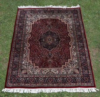 A  blue, red and white ground North Persian rug with central medallion within a multi row border 190cm x 130cm 