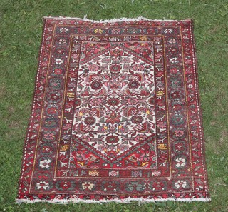 A white, pink and yellow ground Afghan rug with floral diamond shaped medallion to the centre within a multi row border 139cm x 100cm 