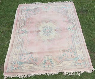 A pink and cream ground floral patterned Chinese carpet with central rose medallion 271cm x 179cm 