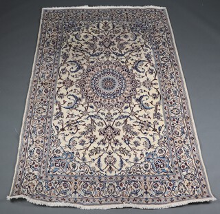 A blue and white floral patterned Persian Nain part silk rug with central medallions, signed to the edge 246cm x 146cm 