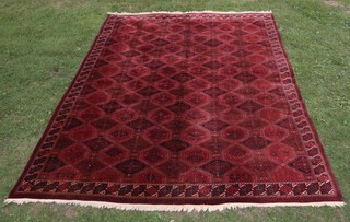 A red, blue and pink ground Bokhara carpet with numerous diamonds to the centre 401cm x 300cm 