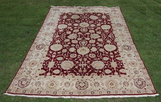 A red and white ground Agra floral patterned carpet 428cm x 296cm 