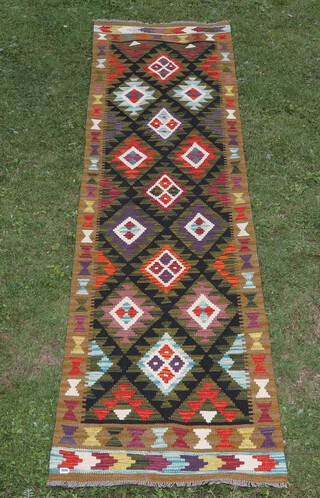 A green black and purple ground Maimana Kilim runner with overall diamond design 295cm x 79cm 