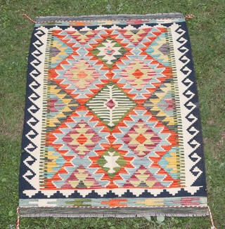 A yellow, white, green and black ground Chobi Kilim rug with overall diamond design 126cm x 81cm 