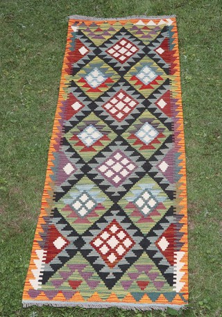 A black, green and tan ground Maimana Kilim runner with overall diamond design 200cm x 69cm 