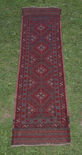 A red and blue ground Meshwani runner with 4 diamonds to centre 252cm x 60cm 