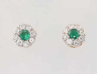A pair of 18ct yellow gold circular emerald and diamond ear studs, the emeralds each 0.20ct, the 16 brilliant cut diamonds each 0.03ct (total 0.50ct), 2.2 grams 