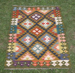 A black, green, white and turquoise ground Maimana Kilim rug with overall geometric designs 145cm x 101cm 