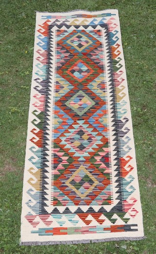 A white, black and tan ground Chobi Kilim runner with 5 diamonds to the centre 199cm x 64cm  