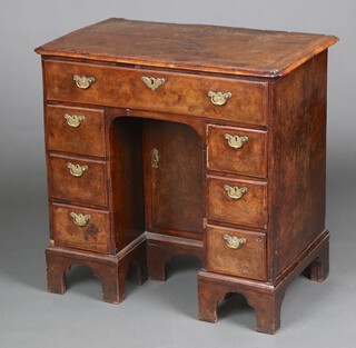 A Queen Anne figured walnut, quarter veneered and crossbanded, pine lined dressing table fitted 1 long drawer, the pedestal fitted a cupboard enclosed by a panelled door, flanked by 6 short drawers, raised on bracket feet 82cm h x 84cm w x 49cm d 