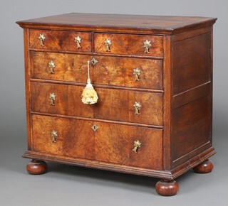 A Queen Anne figured walnut, quarter veneered and crossbanded oak lined chest of 2 short and 3 long drawers with iron locks, having later replacement handles and bun feet 91cm h x 100cm w x 59cm d 