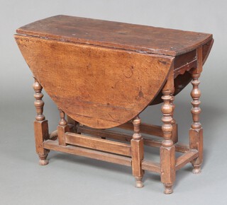 An 18th Century oak oval drop flap gateleg tea table, raised on turned supports 70cm h x 94cm x 34cm 