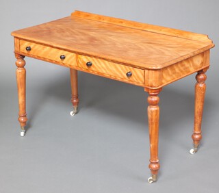 A Victorian satinwood dressing table with raised back, the base fitted 2 drawers with turned ebony handles, raised on turned supports, brass caps and ceramic casters 79cm h x 121cm w x 60cm d 