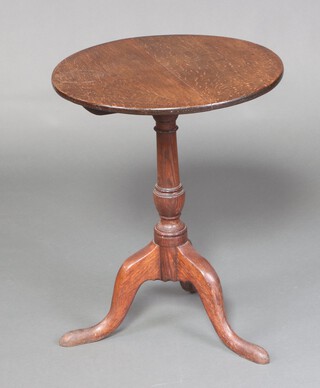 An 18th Century circular oak wine table raised on a pillar and tripod base 70cm h x 55cm diam. 