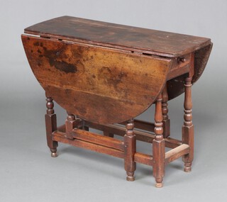 An 18th Century oak gateleg drop flap tea table fitted a frieze drawer, raised on turned supports 69cm h x 93cm w x 34cm d 