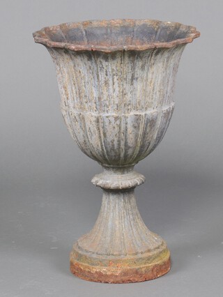 A Victorian style cast iron urn of campanula form, raised on a circular base 62cm h x 43cm diam. 
