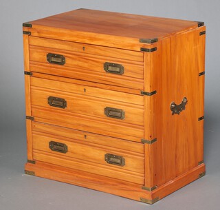 A mahogany finished military style chest of 3 drawers with metal corners and carrying handles to the sides, raised on a platform base 76cm h x 74cm w x 47cm d 