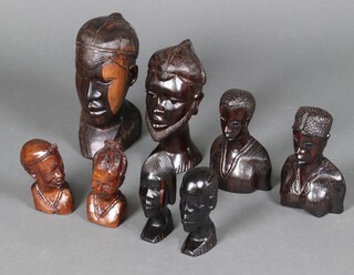 An African carved hardwood head and shoulders portrait bust 27cm and 7 others 