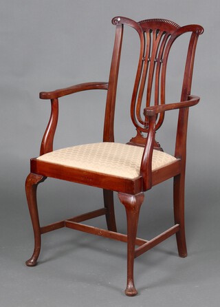 A 1930's Chippendale style mahogany open arm chair with upholstered drop in seat, raised on cabriole supports 103cm h 