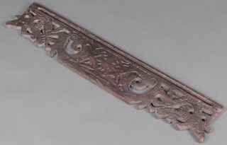 A rectangular pierced and carved hardwood Eastern panel 20cm x 100cm 