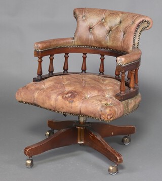 A captains style revolving office chair upholstered in bleached green leather 78cm h x 60cm w x 56cm d (some damage to seat) 