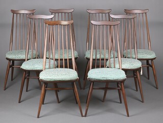 A set of 8 elm Ercol Windsor stick back dining chairs 