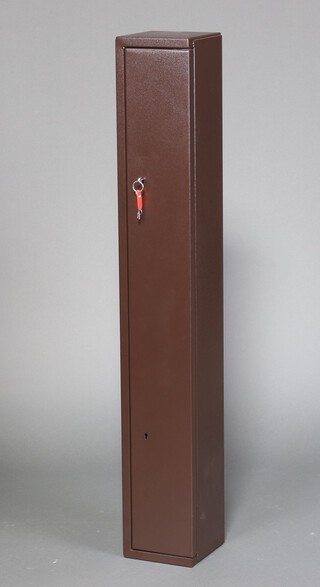 A metal gun cabinet 135cm h x 19cm w x 20cm d, complete with 2 keys 