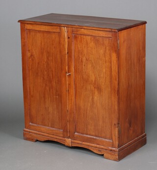 A 19th Century mahogany cabinet enclosed by panelled doors, raised on bun feet 102cm h x 93cm w x 44cm d 
