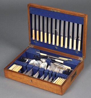 A canteen of silver plated flatware contained in  an oak canteen box 