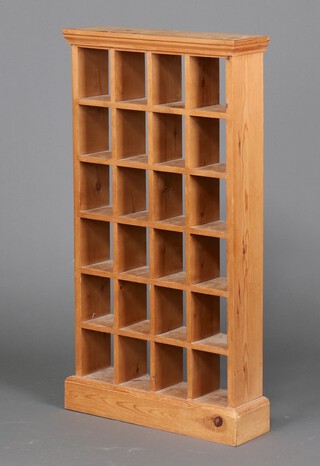 A pine range of 24 pigeon holes, raised on a platform base 96cm h x 56cm w x 15cm d (ring marks) 