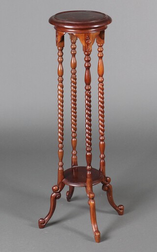 A Victorian style circular 2 tier mahogany jardiniere stand, raised on spiral turned columns with outswept supports 98cm h x 28cm diam. (ring marks to top)