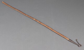 A wooden crook with iron head 
