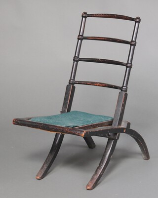 An Arts and Crafts ebonised ladder back folding chair 