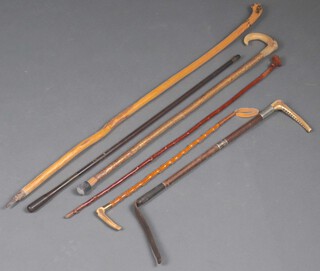 A walking stick with stag horn handle, 2 other walking sticks, 2 hunting crops with stag horn handles, a riding whip and a gun cleaning rod  