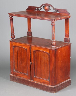 A Victorian mahogany buffet with pierced raised back above recess, the base enclosed by panelled doors, raised on a platform base 120cm h 87cm w x 43cm d 