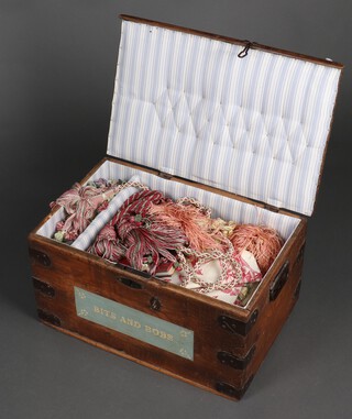 A 19th Century rectangular pine and metal bound trunk with hinged lid 30cm h x 57cm w x 37cm d, together with a collection of fabrics contained within 